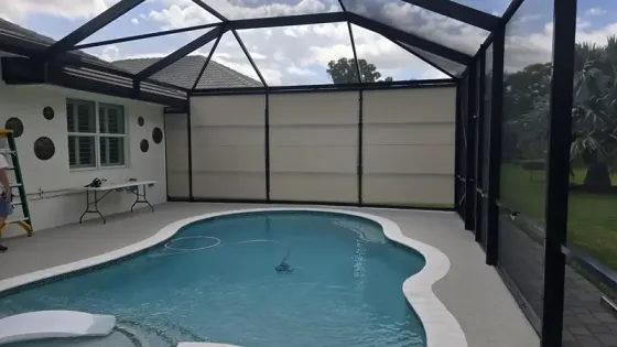 Manual outdoor roller shades with UV-blocking fabric for Florida patio enclosure